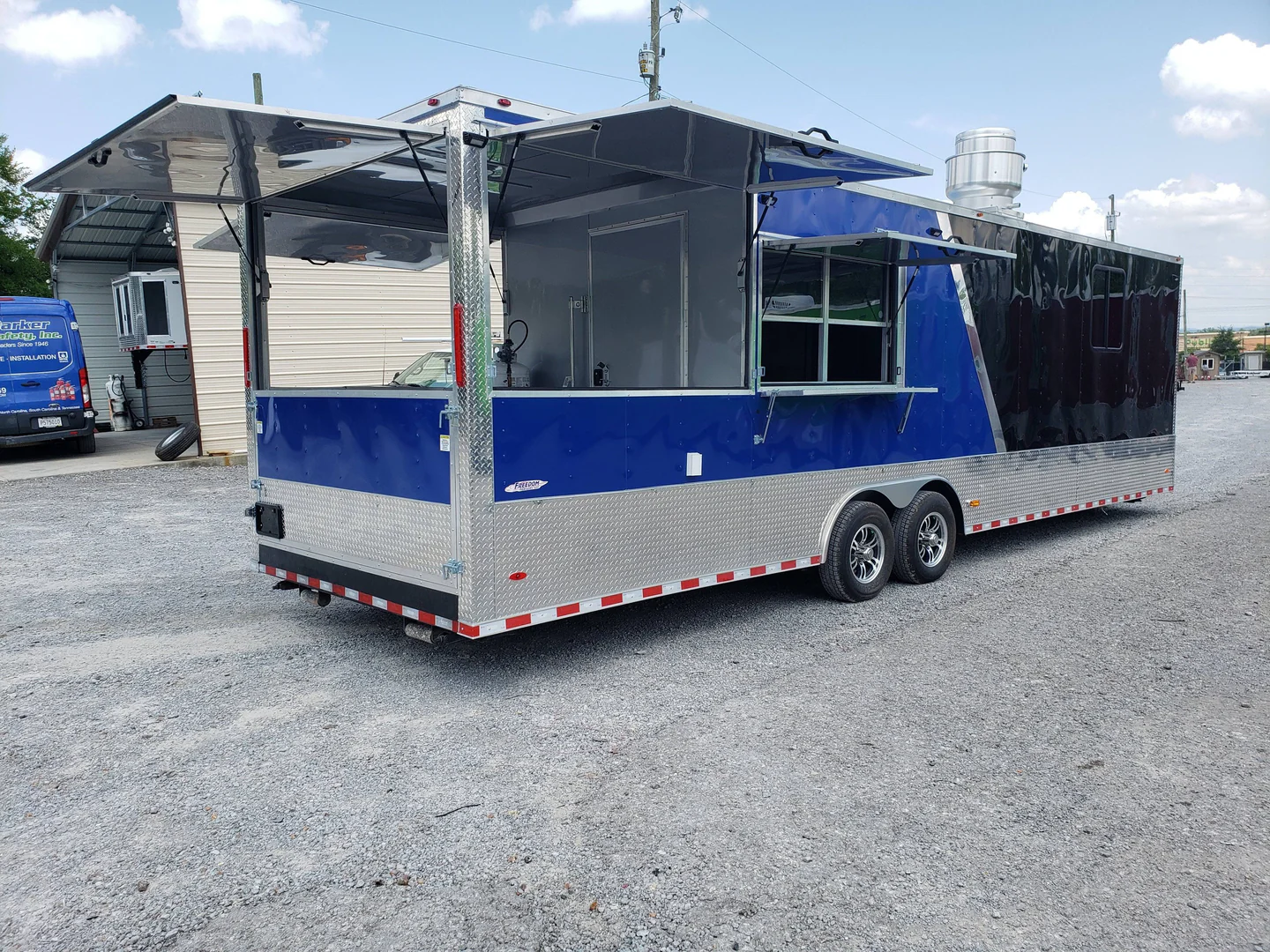 8.5' x 30' Black and Cobalt Blue BBQ Porch Style Concession Trailer